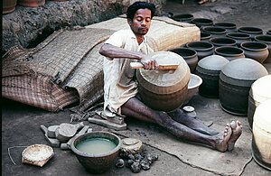 Potter Magha Bishoi finishes forming the largest size of pot. Tikarapada, 1980. 